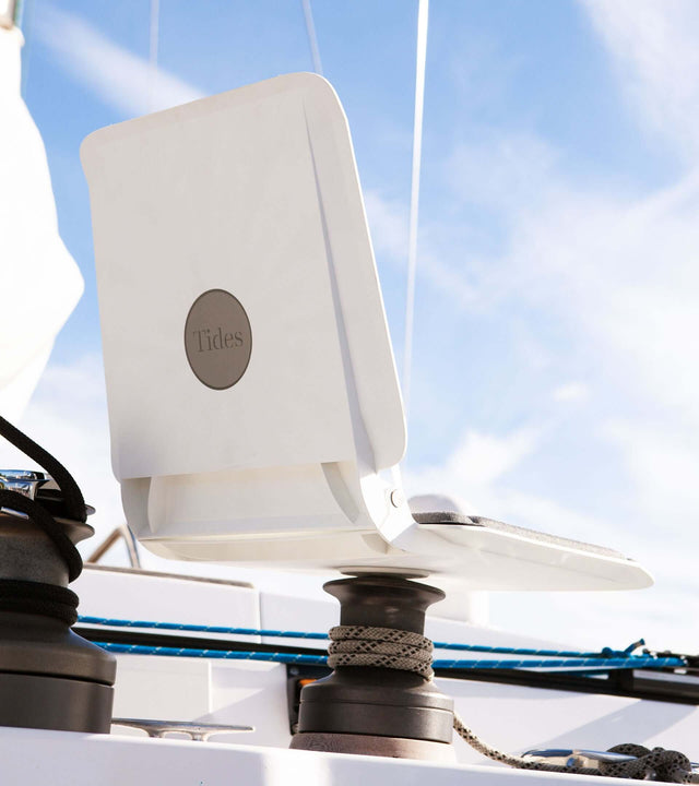 Portable winch seat for sailboat mounted on a winch, offering comfort and support for sailors.
